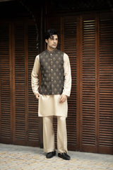 Man wearing a traditional outfit with a vest in front of wooden shutters