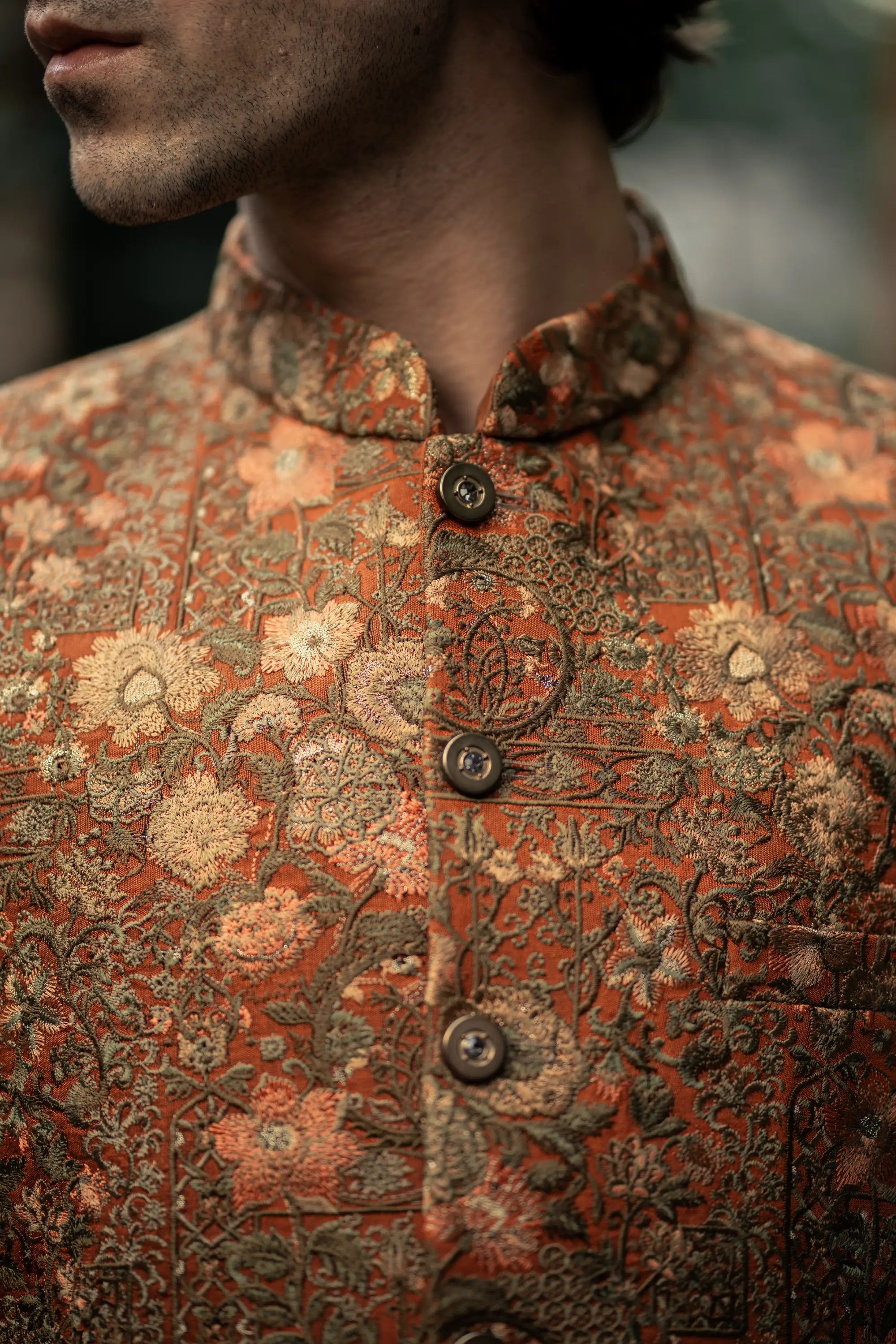 Close-up of a person wearing a patterned garment with intricate designs.