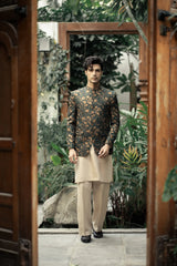 Man in traditional outfit standing in a garden setting